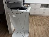a laptop sitting on top of a stand in a room