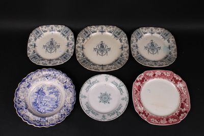 six plates with blue and white designs on them sitting on a black surface