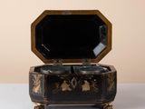 a black and gold box sitting on a white table