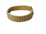 a close up of a gold bracelet on a white background