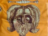 a yellow shirt with a picture of a woman ' s face on it