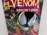 a close up of a comic book with a spider on it