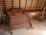 a bed with a wooden headboard and foot board in the middle of a room