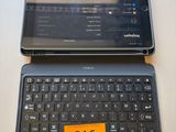 two laptops sitting on a table with a price tag on the keyboard