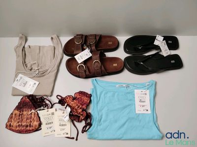 several pairs of sandals, a purse, a t - shirt, and a pair of sandals are on a table