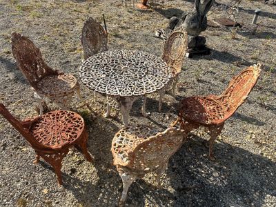 four chairs and a table in the middle of a field