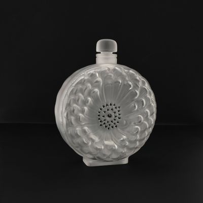 an image of a white glass bottle with a flower design on it