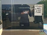 a picture of a man taking a selfie in front of a microwave