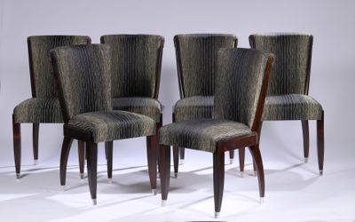 four chairs are lined up in a row on a white surface