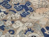 an image of a close up of a blue and white rug with a bird on it