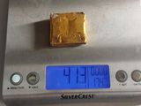 a gold bar sitting on top of a digital scale