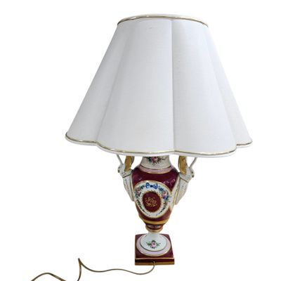 a lamp that is sitting on a table with a white shade
