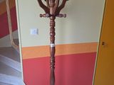 a wooden coat stand in the corner of a room