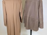 two coats on a mannequin stand on a white background