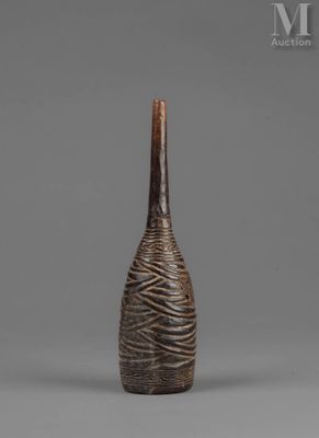a brown vase sitting on top of a table next to a gray wall