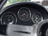 a close up of a car dashboard with gauges and a steering wheel