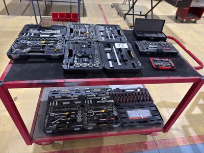 many different tools on a table in a warehouse