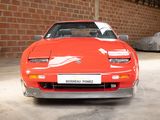 an image of a red sports car parked in a garage