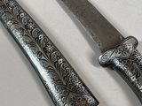 two knives that are sitting next to each other on a table