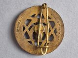 a close up of a gold pin with a star of david on it