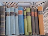 many old books in a white box on a shelf
