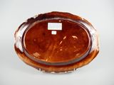 a brown plate with a label on it sitting on a table