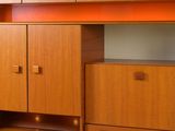 a desk with a computer on it in the corner of a room