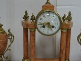 three clocks sitting on top of a table next to each other