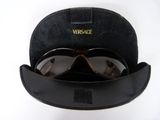 sunglasses in a black hat and sunglasses case on a white surface