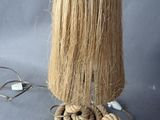 a rope wrapped around a lamp that is on a table