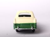 a green and white toy car on a white surface