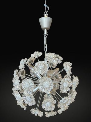 an image of a white chandelier hanging from a ceiling