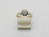 a close up of a diamond ring on a white surface