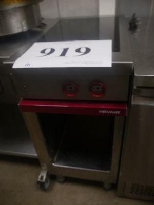 a stove with a sign on top of it in a kitchen