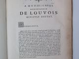 an open book with a picture of a coat of arms on it