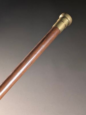 a close up of a wooden stick with a metal handle