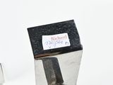 a small metal object with a sticker on it