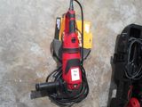 a picture of a corded drill and other tools laid out on the floor