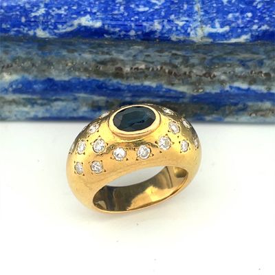 an image of a gold ring with a blue stone on it