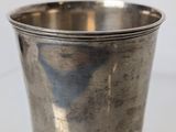 a silver cup that is sitting on a table