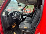 the interior of a red truck with the door open and the driver ' s seat down