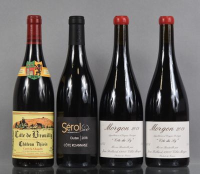 three bottles of wine are lined up on a table
