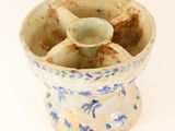 a small blue and white bowl with a spoon in it