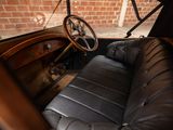 a black leather seat in the back of an old car