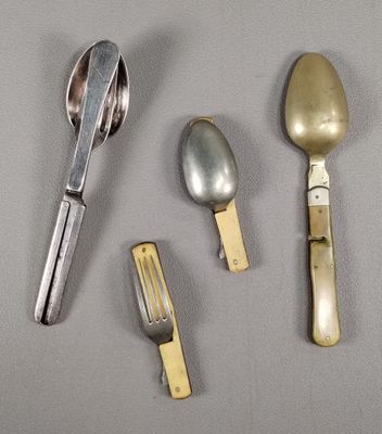 three spoons, a fork, and a knife on a table