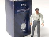 a figurine of a man standing next to a box