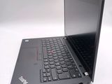 a laptop with a black keyboard on a white surface