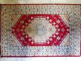 an image of a red and white rug on a white surface