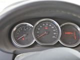 a close up of a car dashboard with gauges and speedometers
