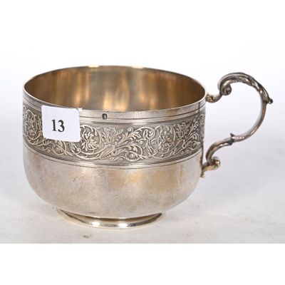 an antique silver cup with a handle and handles on a white background